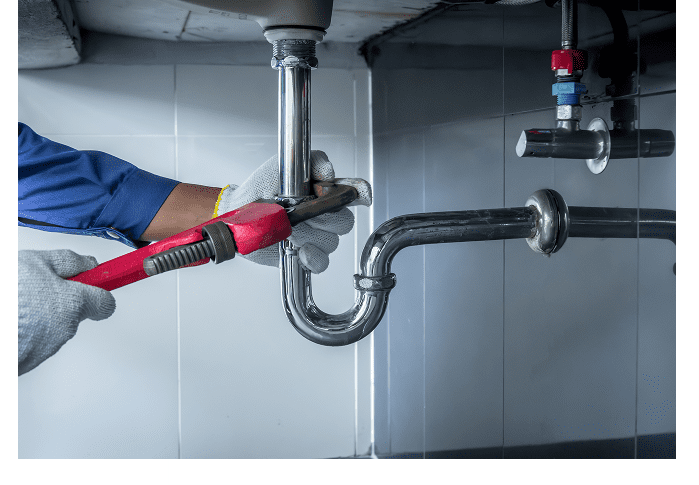 Plumber fixing pipe with adjustable wrench.